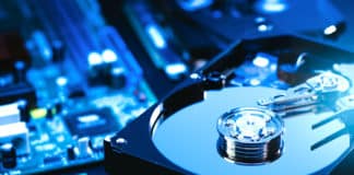 A hard disk drive (HDD) rests on computer motherboard.