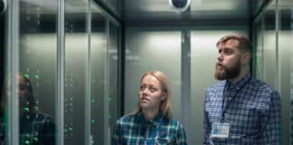 A pair of employees examine servers in a data center.