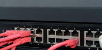 Cables connect to ports in a network router.