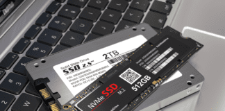 A harddisk drive and a memory module atop a laptop..