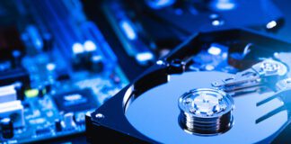 The abstract image of inside of hard disk drive on the technician's desk and a computer motherboard as a component. the concept of data, hardware, and information technology.