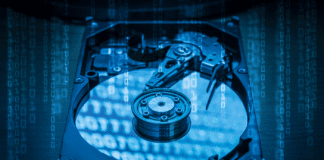 Abstract image of inside of hard disk drive and binary code hologram on top.