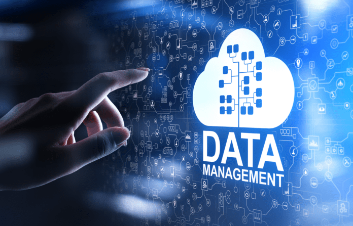 Female hand interacting with a Data Management icon on a virtual screen.